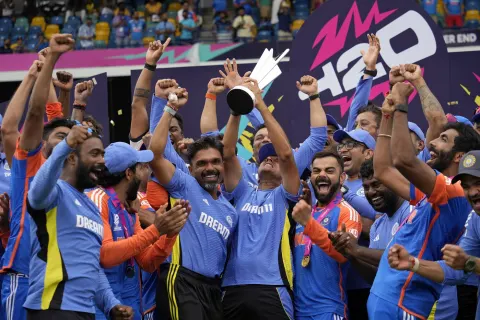 Rahul Dravid lifts the trophy as the team celebrates•Jun 29, 2024•Associated Press